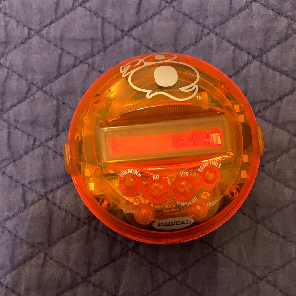 Radica Orange Handheld Electronic Game. 20 questions